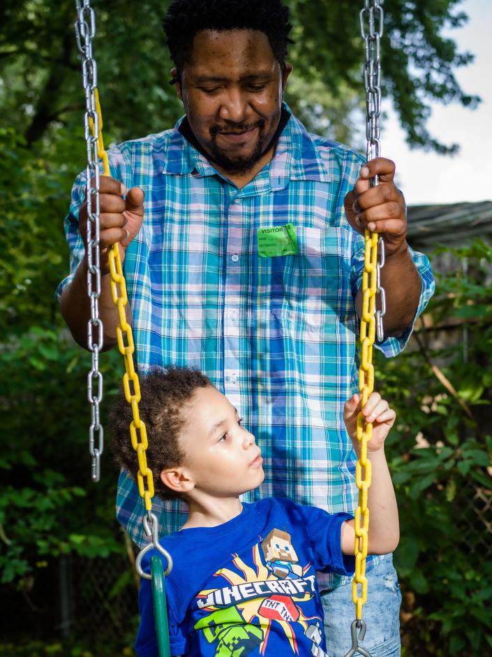 Clareon Williams plays with his father in the backyard of their home in Marham, Ill., on Aug. 10.