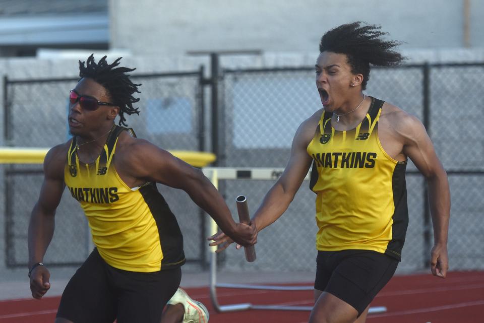 Watkins Memorial's Jaleel Sales takes the baton from Isaac Scott on the 4x100 anchor leg Friday during the LCL-Buckeye Division meet at Ascena Field. The Warriors won in :43.05.