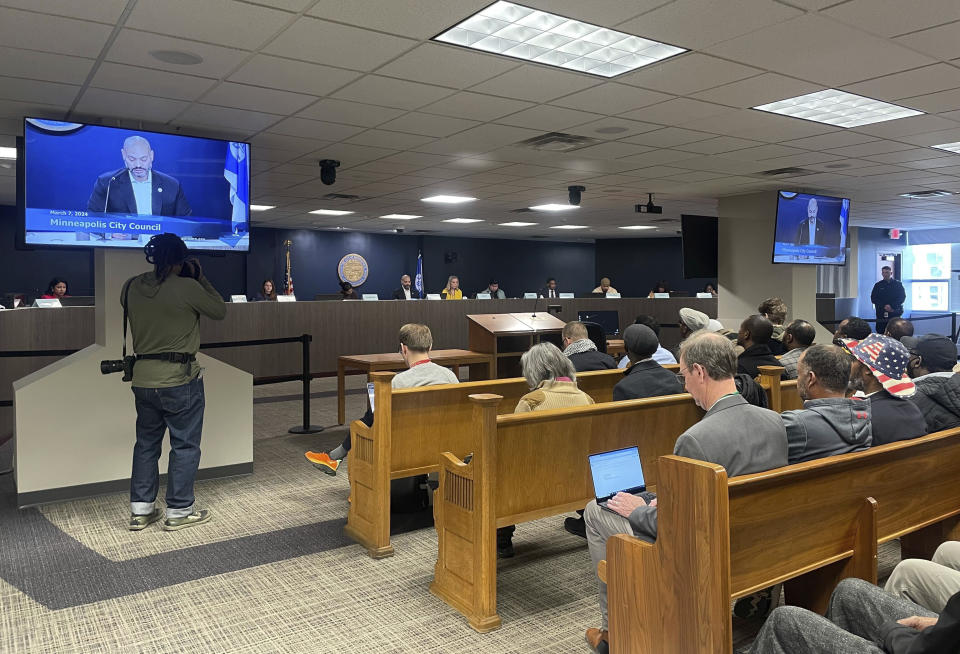 Ride-hailing drivers sit in the audience of the city council chambers in Minneapolis, Thursday, March 7, 2024, as council members discuss a measure that would increase wages to drivers of ride-hailing companies, including Uber and Lyft, to an equivalent of more than $15 an hour. Opponents say this may increase costs to customers and increase fears that Uber and Lyft will follow through on their threats to leave the area altogether. (AP Photo/Trisha Ahmed)