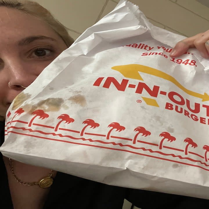 The author in a selfie with an In N Out bag