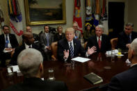 U.S. President Donald Trump, flanked by Kenneth Frazier (L) CEO of Merck, Robert Hugin (2nd R) Executive Chairman of Celgene and Robert Bradway (R) CEO of Amgen meets with Pharma industry representatives at the White House in Washington, U.S., January 31, 2017. REUTERS/Yuri Gripas