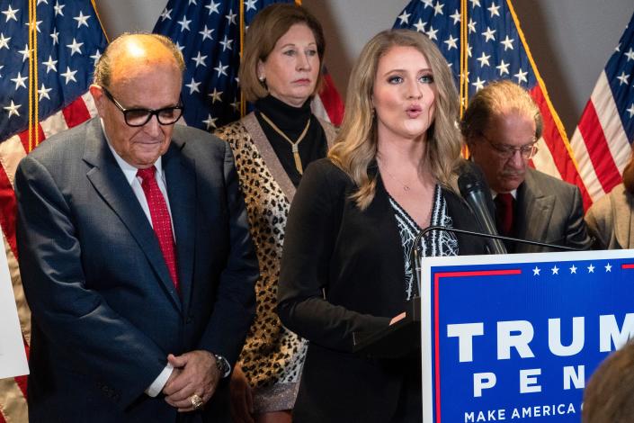 Members of President Donald Trump's legal team, including former Mayor of New York Rudy Giuliani, left, Sidney Powell, and Jenna Ellis, speaking, attend a news conference at the Republican National Committee headquarters, Thursday Nov. 19, 2020, in Washington.