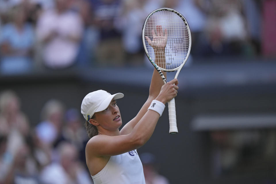 Poland's Iga Swiatek reacts after beating Croatia's Petra Martic in a women's singles match on day five of the Wimbledon tennis championships in London, Friday, July 7, 2023. (AP Photo/Alberto Pezzali)