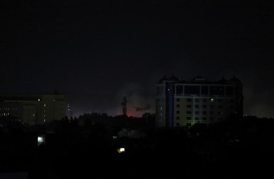 Smoke rises next to the U.S. Embassy in Kabul late on Aug. 15.<span class="copyright">Rahmat Gul—AP</span>