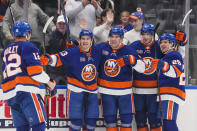 New York Islanders center Bo Horvat (14) celebrates with teammates Sebastian Aho (25),Mathew Barzal (13), Noah Dobson (8) and Josh Bailey (12) after scoring a goal during the second period of an NHL hockey game against the Seattle Kraken, Tuesday, Feb. 7, 2023, in Elmont, N.Y. (AP Photo/Frank Franklin II)