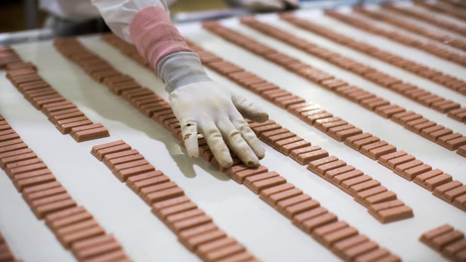 A Japanese worker checks strawberry flavor Kit Kat bars in 2017. - Behrouz Mehri/AFP/Getty Images