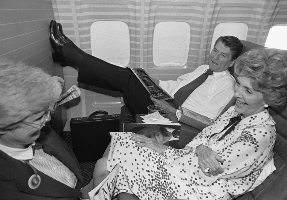 FILE - In this July 19, 1980 file photo taken byWalt Zeboski, Republican presidential nominee Ronald Reagan props his feet up as wife Nancy, foreground, talks with unidentified woman aboard an airplane, in Los Angeles, bringing the Reagan's back home to California from a brief stopover in Texas. Former Associated Press photographer Walt Zeboski, who chronicled California politics for 30 years and Ronald Reagan’s 1980 presidential campaign, died at age 83 Monday. (AP Photo/Walt Zeboski, File)