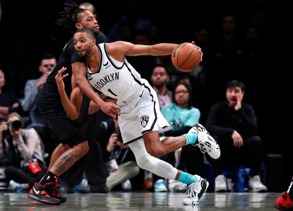 Nets forward Mikal Bridges drives to the basket against Cavaliers guard Darius Garland during the first half of their game, March 23 in New York.