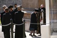 <p>The queen makes her entrance to the chapel. </p>