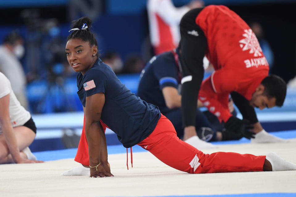 Simone Biles warms up ahead of her balance beam event at the Tokyo Olympics. - Credit: Mirrorpix / MEGA