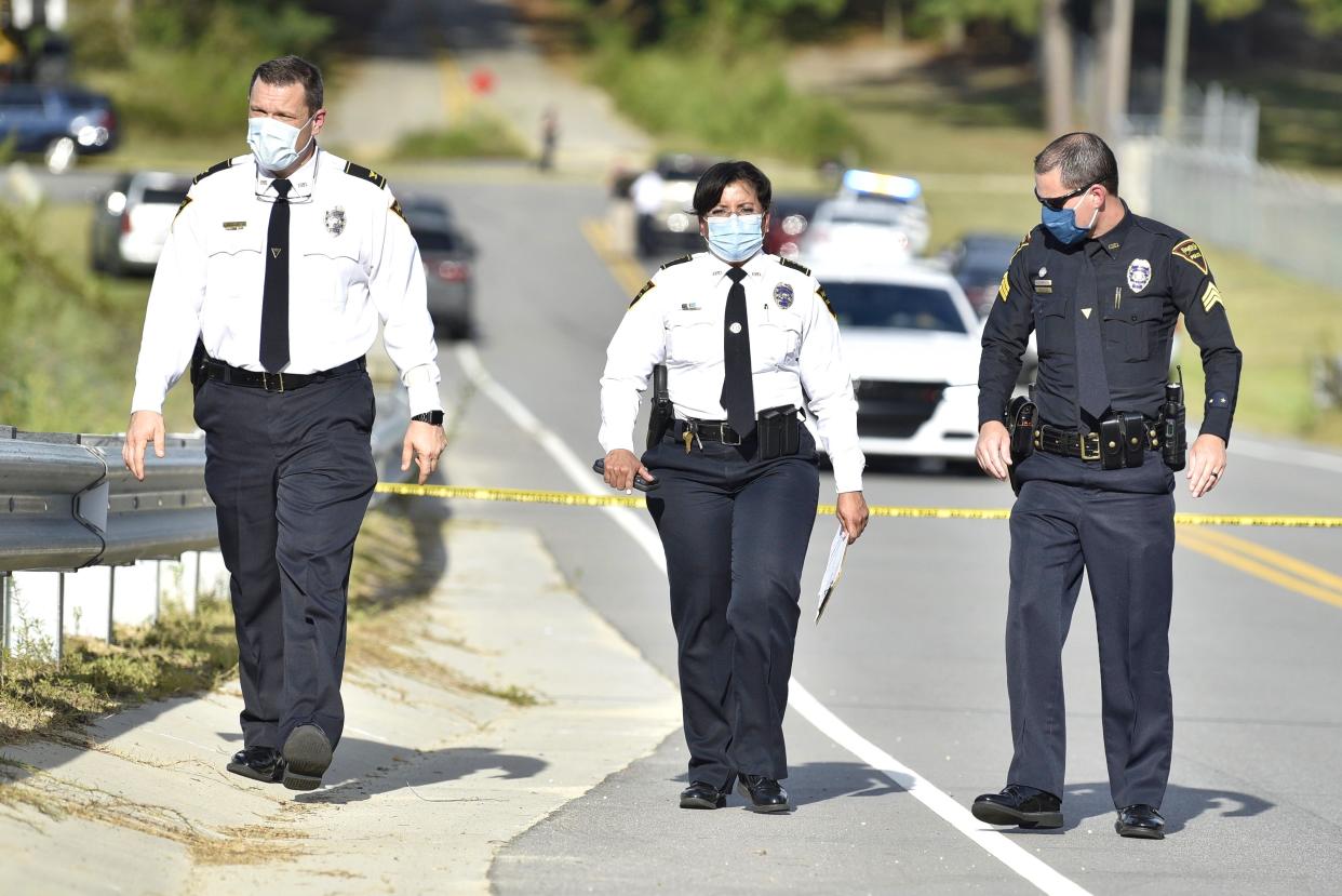 Fayetteville Police Chief Gina Hawkins, center, prepares to talk with reporters about an officer-involved shooting in September 2020. Hawkins is the subject of an ethics violation complaint. An ethics hearing last week was continued to January.