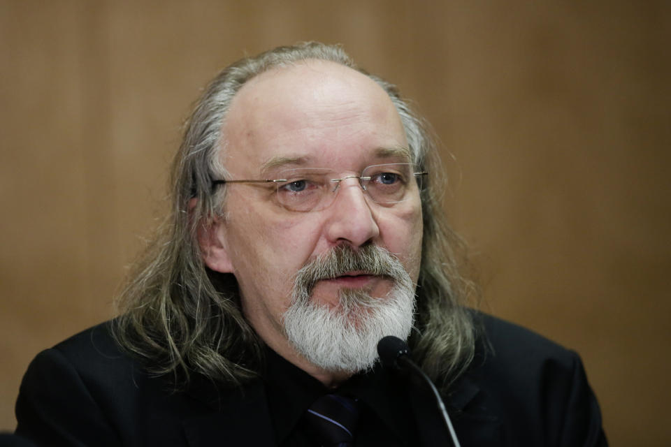 Tim van Beveren explains his expertise during a news conference hosted by, Guenter Lubitz, father of the Germanwings co-pilot of the plane crash in the French Alps, in Berlin, Friday, March 24 2017. Two years ago, the Germanwings machine 4U 9525 crashed in the Southern French Alps, killing 150 people. (AP Photo/Markus Schreiber)