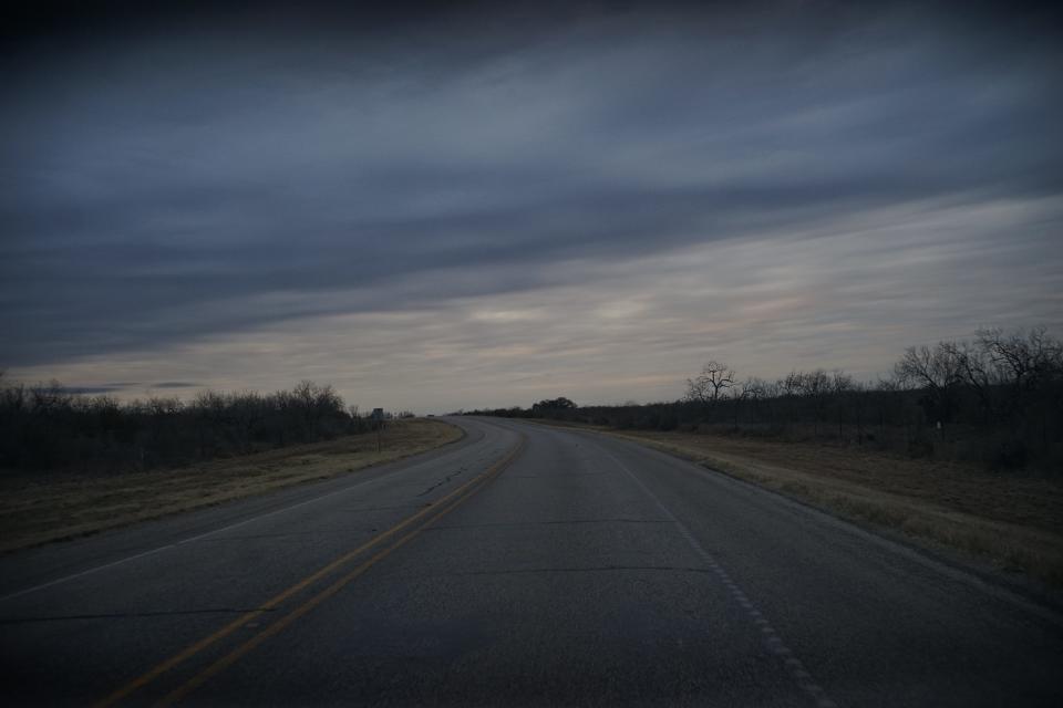 An open road at sundown.