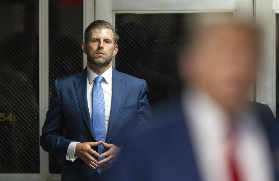 Eric Trump listens as his father former President Donald Trump speaks with the media leaves as he leaves the courtroom following the day's proceedings in his trial at Manhattan criminal court in New York, Tuesday, April 30, 2024. (Justin Lane/Pool Photo via AP)