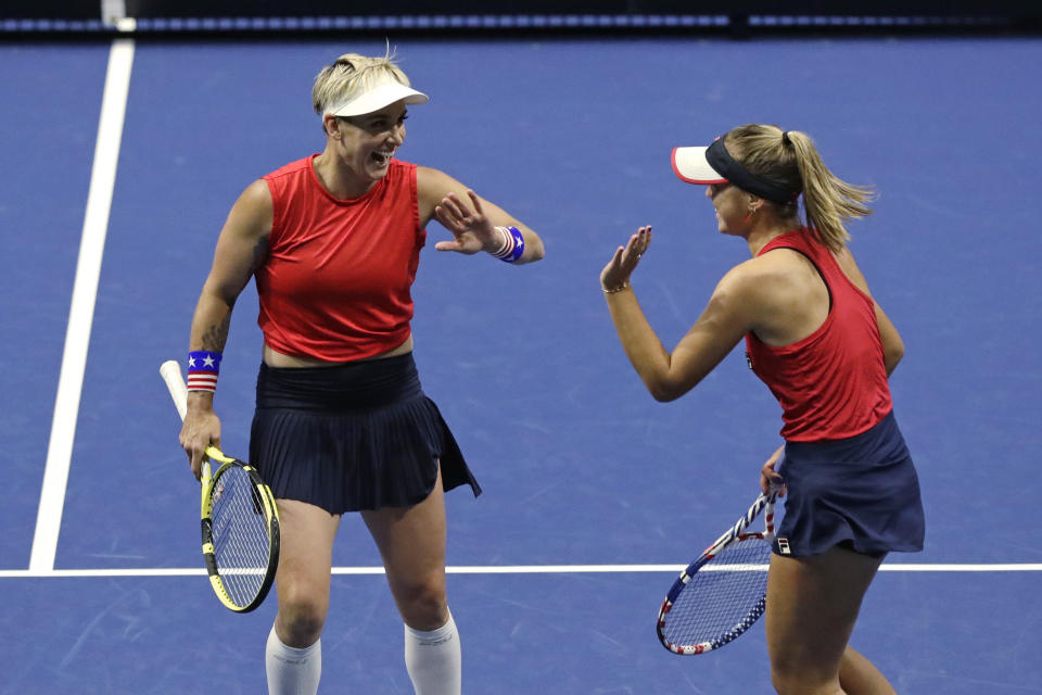United States' Bethanie Mattek-Sands, left, and Sofia Kenin share congratulations after winning a point against Latvia's Jelena Ostapenko and Anastasija Sevastova during the doubles match in a Fed Cup tennis qualifying tie Saturday, Feb. 8, 2020, in Everett, Wash. (AP Photo/Elaine Thompson)
