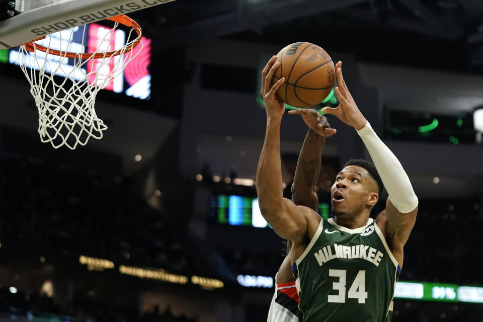 Milwaukee Bucks' Giannis Antetokounmpo shoots past Portland Trail Blazers' Jerami Grant during the second half of an NBA basketball game, Sunday, Nov. 26, 2023, in Milwaukee. (AP Photo/Aaron Gash)