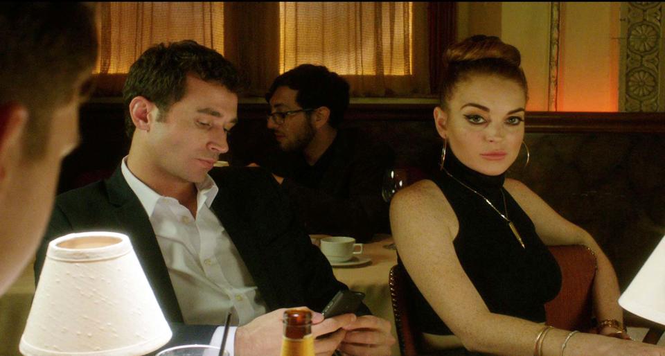 This film image released by IFC Films shows Lindsay Lohan, right, and James Deen in a scene from "The Canyons." (AP Photo/IFC Films)