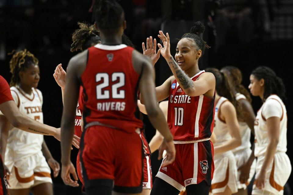 Aziaha James, right, scored 27 points to lead N.C. State to a 76-66 upset of top-seeded Texas in Sunday's NCAA Tournament regional final in Portland, Oregon.