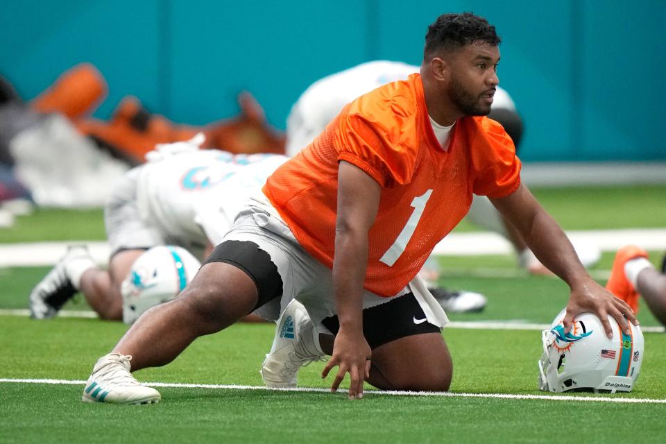 Miami Dolphins quarterback Tua Tagovailoa (1) stretches during practice at the NFL football team's training facility, Tuesday, June 6, 2023, in Miami Gardens, Fla.