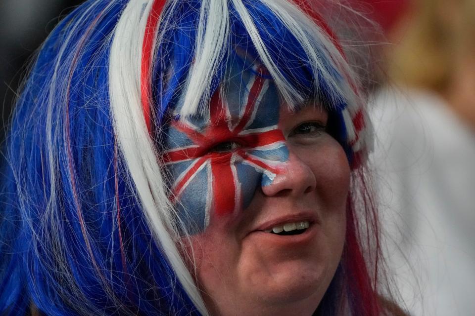 A royal fan with face paint and colored hair is seen prior to the Platinum Jubilee concert (AP)