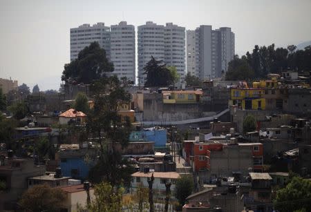 New buildings are seen behind a low-income neighborhood in Mexico City March 5, 2011. REUTERS/Jorge Dan Lopez