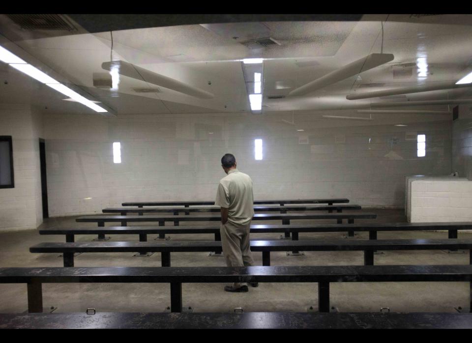 FILE - This Jan. 11, 2012 file photo shows a man waiting to be processed at a Border Patrol detention center in Imperial Beach, Calif. With border crossings at a 40-year low, the U.S. Border Patrol announced a new strategy Tuesday, May 8, 2012 that targets repeat crossers and tries to find out why they keeping coming. For nearly two decades, the Border Patrol has relied on a strategy that blanketed heavily trafficked corridors for illegal immigrants with agents, pushing migrants to more remote areas where they would presumably be easier to capture and discouraged from trying again. (AP Photo/Gregory Bull, File)