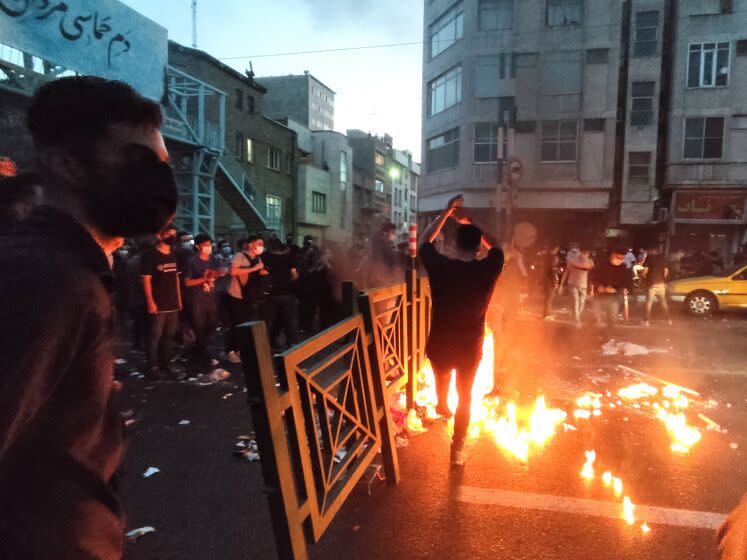 TOPSHOT - A picture obtained by AFP outside Iran on September 21, 2022, shows Iranian demonstrators taking to the streets of the capital Tehran during a protest for Mahsa Amini, days after she died in police custody. - Protests spread to 15 cities across Iran overnight over the death of the young woman Mahsa Amini after her arrest by the country's morality police, state media reported today.In the fifth night of street rallies, police used tear gas and made arrests to disperse crowds of up to 1,000 people, the official IRNA news agency said. (Photo by AFP) (Photo by -/AFP via Getty Images)