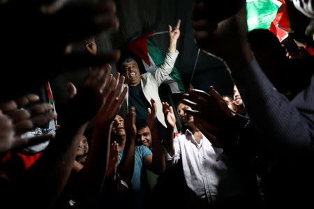 People celebrate inside the Palestinian Bedouin village of Khan al-Ahmar that Israel plans to demolish, in the occupied West Bank October 20, 2018. REUTERS/Mohamad Torokman