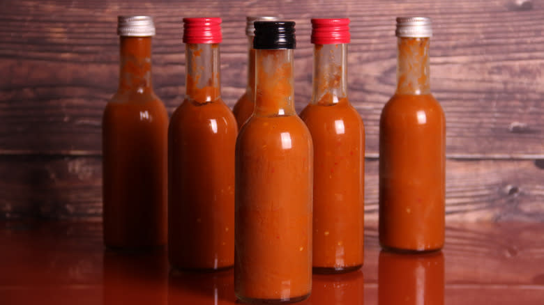 Bottles of hot sauce on table