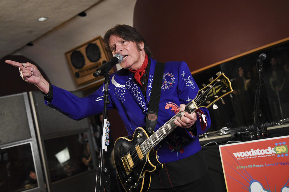 FILE - In this March 19, 2019 file photo, musician John Fogerty performs at the Woodstock 50 lineup announcement at Electric Lady Studios in New York. For the first time, an audio recording, "Woodstock - Back to the Garden - The Definitive Anniversary Archive," is available of nearly everything heard onstage at Woodstock 50 years ago. Creedence Clearwater Revival, one of the most popular acts at the time, had never before authorized release of their performance, but the set is now available both on the Rhino Records box and a separate disc okayed by Fogerty. (Photo by Evan Agostini/Invision/AP, File)