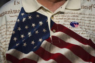 A man wears an "I voted" sticker on his shirt, printed with the American flag and the U.S. constitution, after voting at Wa-Ke Hatchee Recreation Center in Fort Myers, Fla, on Election Day, Tuesday, Nov. 8, 2022. After the area was devastated and thousands were left displaced by Hurricane Ian, Lee County extended their early voting period and permitted voters on Election Day to cast their ballot in any of the dozen open polling places. (AP Photo/Rebecca Blackwell)