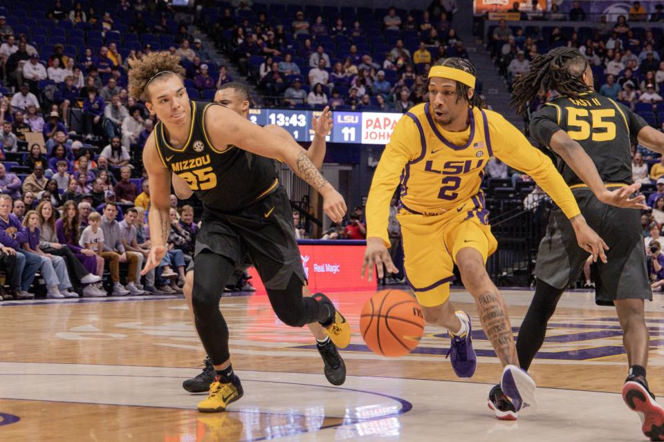 Mar 9, 2024; Baton Rouge, Louisiana, USA; LSU Tigers guard Mike Williams III (2) dribbles against Missouri Tigers forward Noah Carter (35) during the first half at Pete Maravich Assembly Center. Mandatory Credit: Stephen Lew-USA TODAY Sports