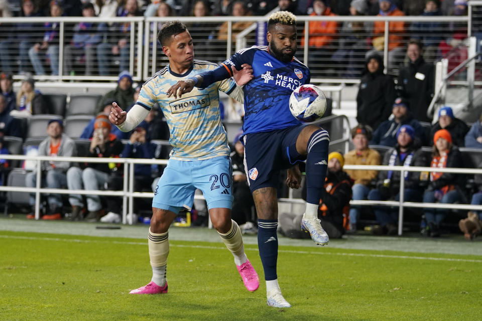 Philadelphia Union midfielder Jesús Bueno (20) and FC Cincinnati forward Aaron Boupendza, right, battle for the ball during the second half of an MLS Eastern Conference semifinals playoff soccer match, Saturday, Nov. 25, 2023, in Cincinnati. (AP Photo/Carolyn Kaster)