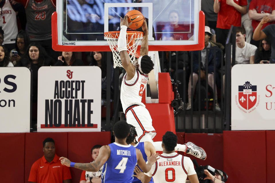 St. John's guard AJ Storr (2) dunks the ball as Creighton guard Shereef Mitchell (4) and St. John's guard Posh Alexander (0) watch during the first half of an NCAA college basketball game Saturday, Feb. 18, 2023, in New York. (AP Photo/Jessie Alcheh)