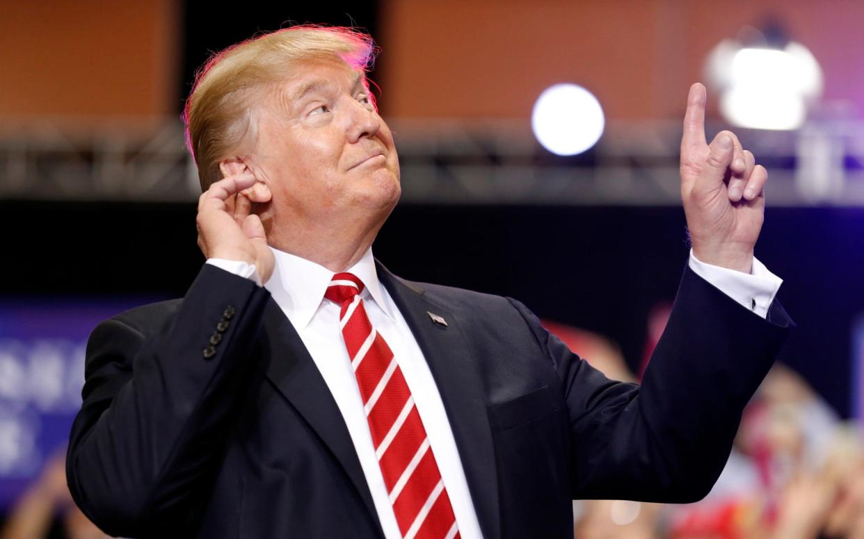 President Donald Trump reacts to the song as he arrives at a rally at the Phoenix Convention Centre - AP