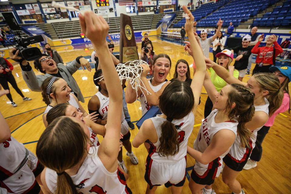 Shallowater's Sidney Venable celebrates with her team and trophy after Shallowater defeats Jim Ned, 43-37, in the Region I-3A final girls basketball game, Saturday, Feb. 24, 2024, at the Tiger Pit in Wolfforth.