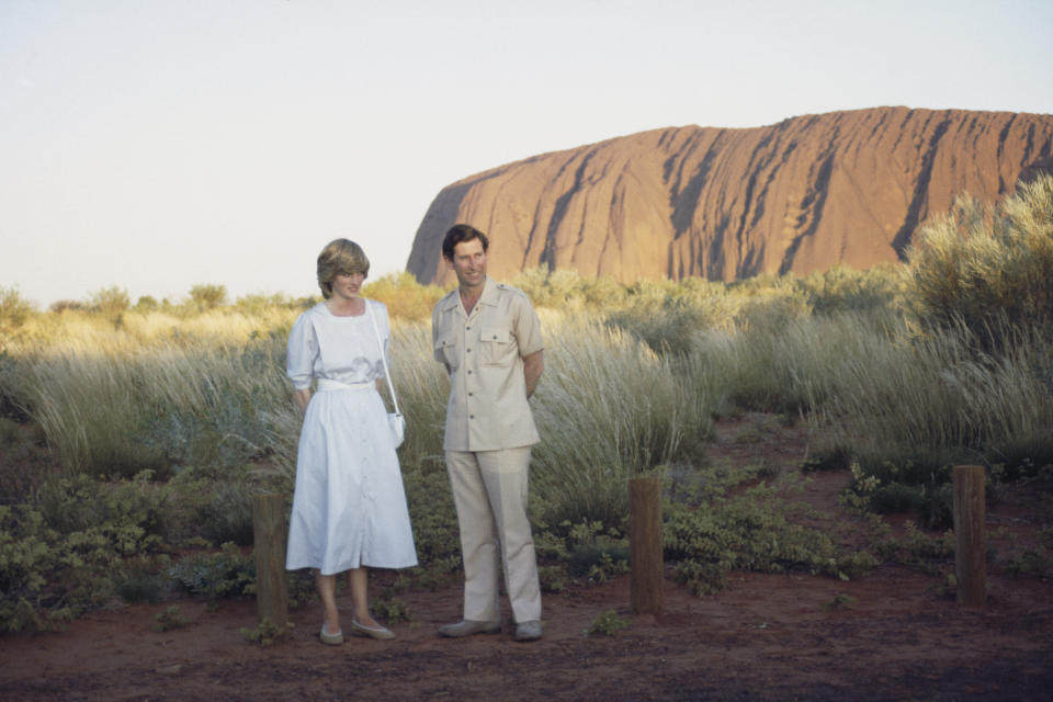 Diana Princess of Wales (1961 - 1997) and Prince Charles pose in front of Uluru/Ayers Rock near Alice Springs, Australia during the Royal Tour of Australia, 21st March 1983. Diana is wearing a dress designed by Benny Ong.  (Photo by Jayne Fincher/Princess Diana Archive/Hulton Archive/Getty Images)