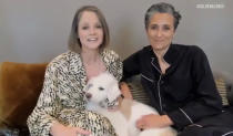 In this video grab issued Sunday, Feb. 28, 2021, by NBC, Jodie Foster, left, holding her dog Ziggy, accepts the award for best supporting actress in a motion picture for "The Mauritanian" as her wife Alexandra Hedison looks on at right at the Golden Globe Awards. (NBC via AP)