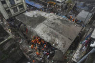 Rescuers look for survivors after a residential building collapsed in Bhiwandi in Thane district, a suburb of Mumbai, India, Monday, Sept.21, 2020. (AP Photo/Praful Gangurde)