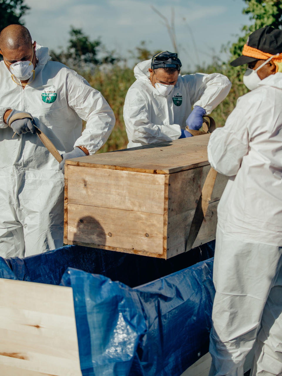 Workers place Ellen Torron’s exhumed casket into an oversized one for a cross-city trip to Mount Richmond cemetery in Staten Island.<span class="copyright">Sasha Arutyunova for TIME</span>