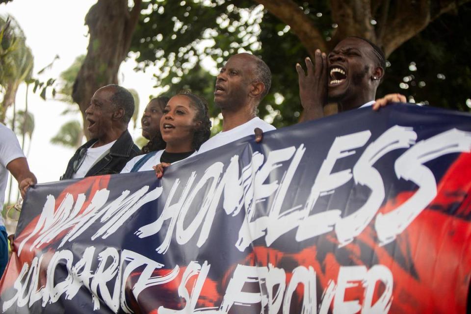 Protesters hold up a sign during a protest at Lummus Park in Miami Beach on Saturday August 3rd, 2024.