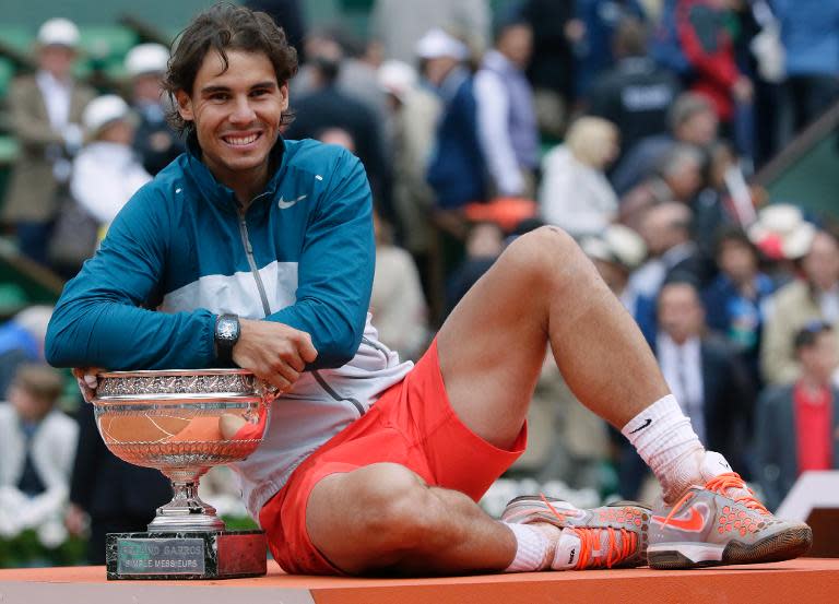 Spain's Rafael Nadal poses with the trophy after he won the 2013 French Open final against compatriot David Ferrer, at the Roland Garros stadium in Paris, on June 9, 2013