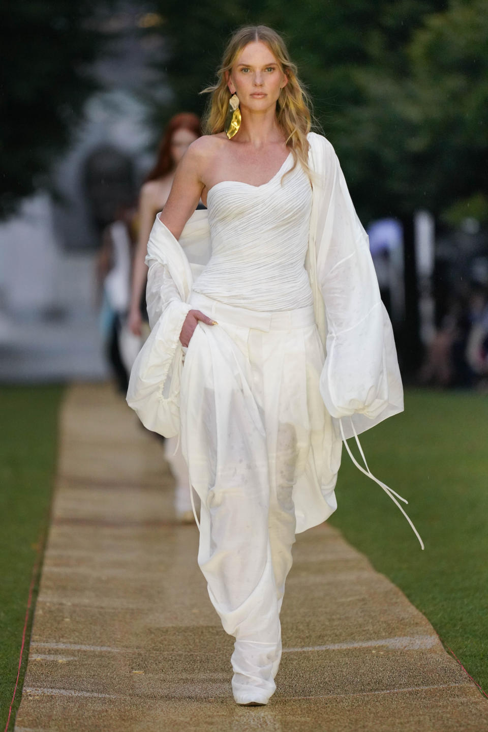 A model walks down the Prabal Gurung runway in an all white outfit Beyonce wore for the Cered party