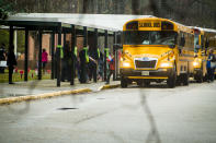 Students exit a school bus during the first day back to Richneck Elementary School on Monday Jan. 30, 2023 in Newport News, Va. The Virginia elementary school where a 6-year-old boy shot his teacher has reopened with stepped-up security and a new administrator.(AP Photo/John C. Clark)