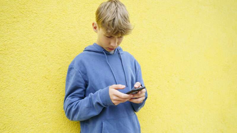 teen typing on cell phone