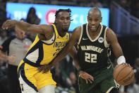 Milwaukee Bucks' Khris Middleton tries to get past Indiana Pacers' Aaron Nesmith during the first half of Game 5 of the NBA playoff basketball series Tuesday, April 30, 2024, in Milwaukee. (AP Photo/Morry Gash)