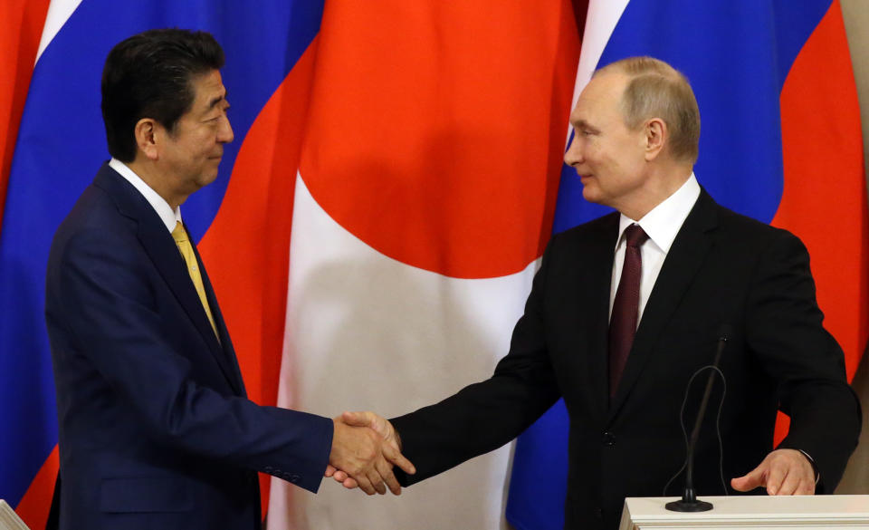 MOSCOW, RUSSIA - JANUARY, 22 (RUSSIA OUT)  Russian President Vladimir Putin (R) and Japanese Prime Minister Shinzo Abe (L) shakes hands during their press conference at the Kremlin on January 22, 2019 in Moscow, Russia. Japanese Prime Minister Shinzo Abe has arrived to Moscow to talk about the Kuril Islands dispute. (Photo by Mikhail Svetlov/Getty Images)