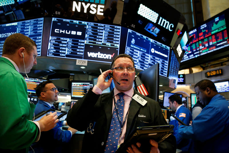 FILE PHOTO: Traders work on the floor of the New York Stock Exchange (NYSE) in New York, U.S., May 18, 2018. REUTERS/Brendan McDermid