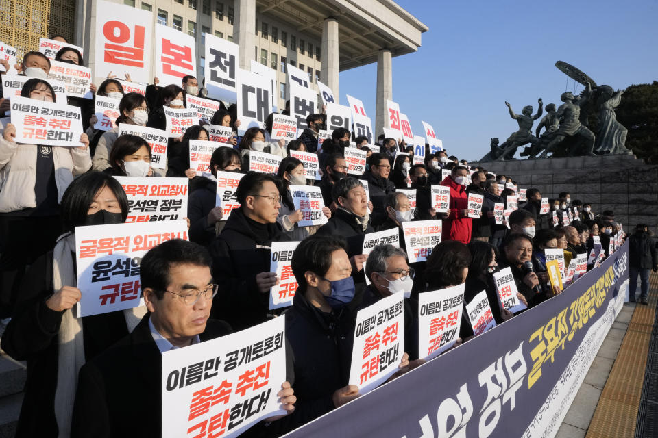 Members of a civic group seeking compensation from Japanese firms over forced labor during World War II and opposition lawmakers stage a rally to oppose the government's reported resolution to the issue outside the National Assembly in Seoul, Thursday, Jan. 12, 2023. The banners read "Apology and compensation from Japanese war criminal companies and condemn the government of President Yoon Suk Yeol." (AP Photo/Ahn Young-joon)