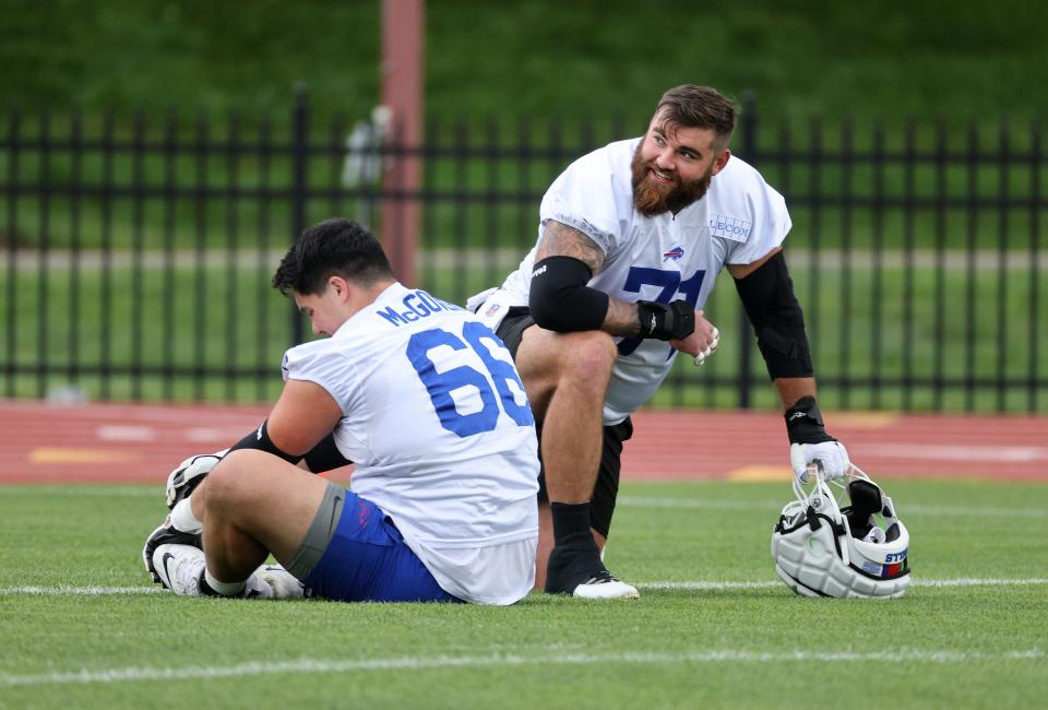 Bills offensive linemen Ryan Bates (71) and Connor McGovern get out to the practice field early.